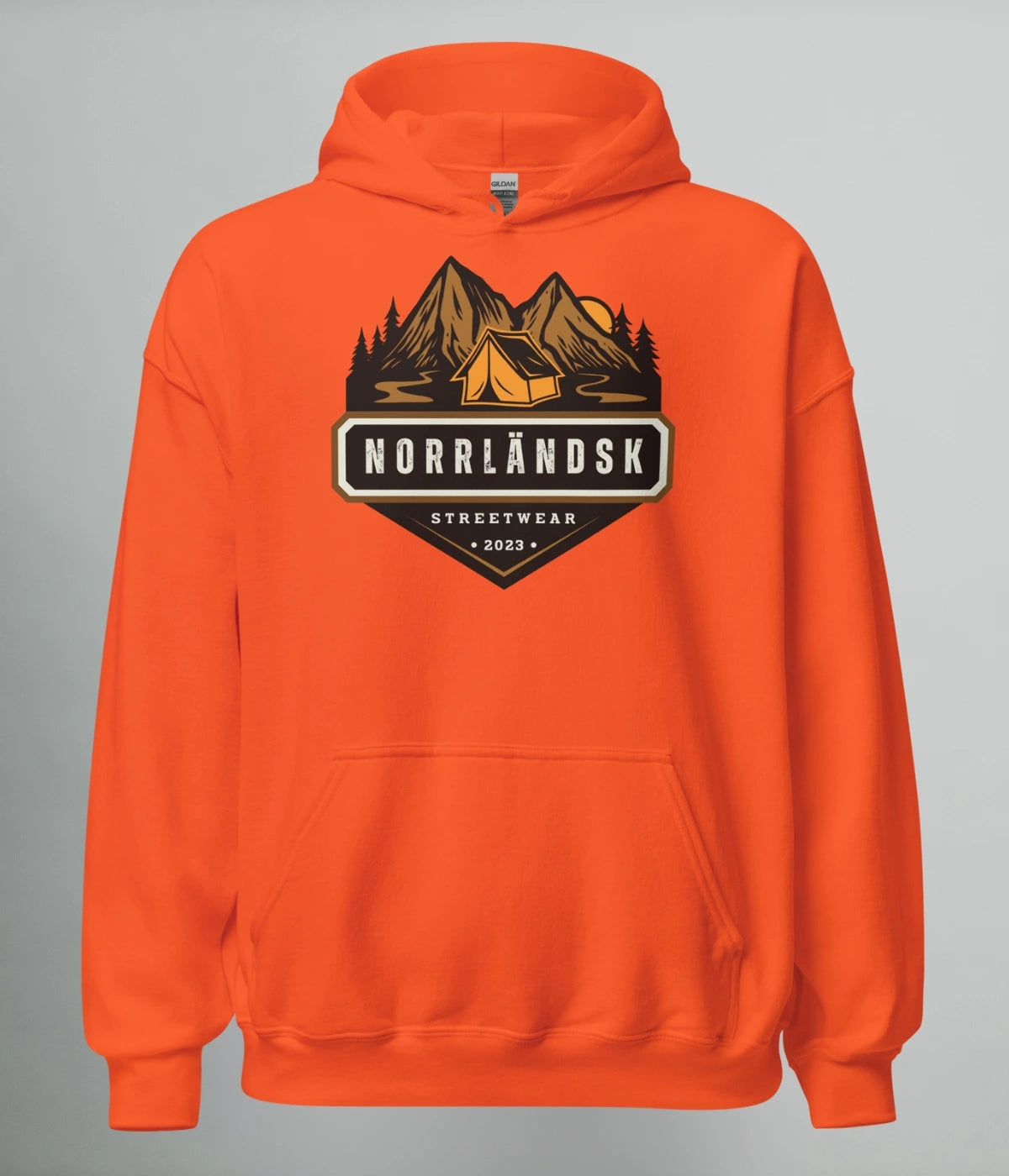 Orange hoodie med illustration av fjäll, skog och stuga – Norrländsk streetwear med texten "Norrländsk Stugliv Streetwear 2023" från Heart of North.